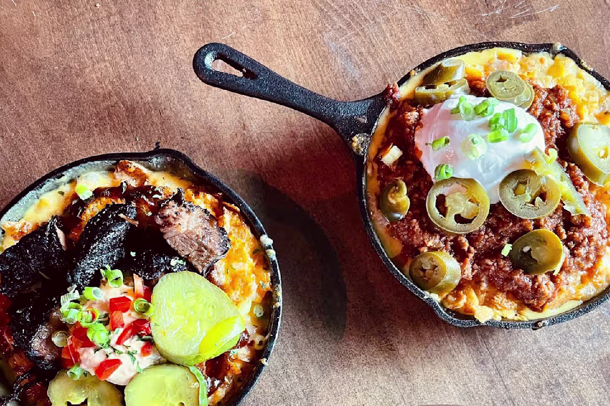 Daddy Mac's Down Home Dive signature dishes Doc's Down Home Egg Rolls, Piled High TOTS, Burnt Ends Mac, Frito Pie Mac.